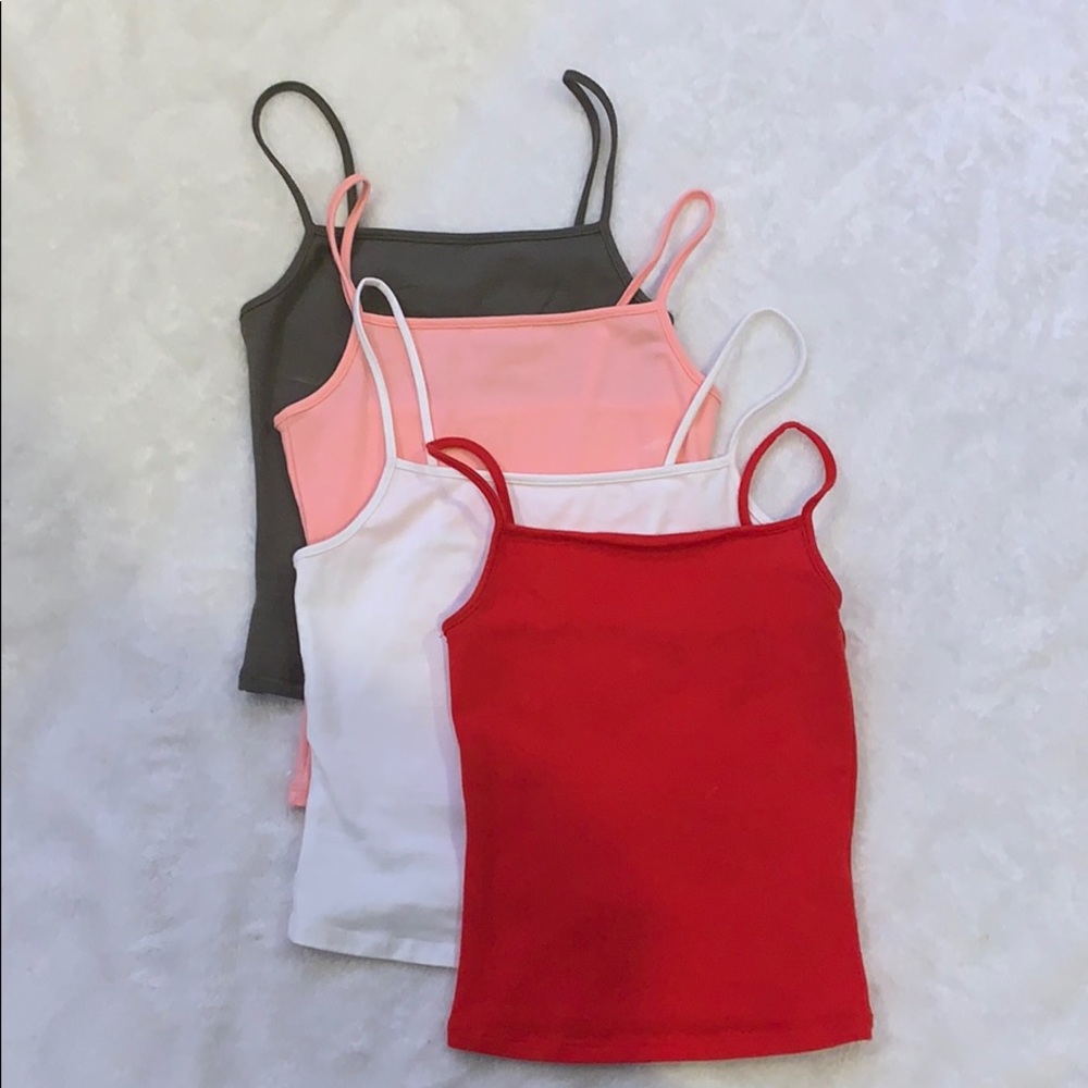 four different colors of garage tank tops, size xs